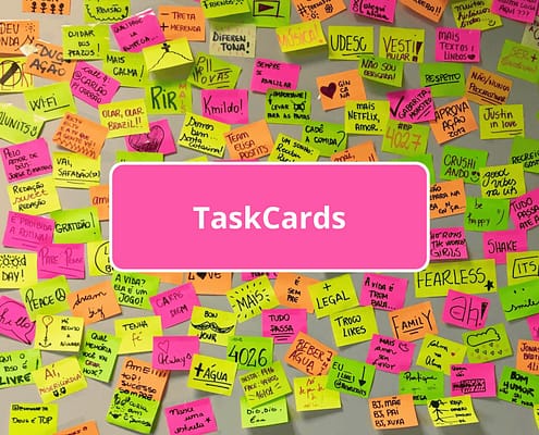 Viele beschriebende Klebezettel an einer Wand und Schrift TaskCards